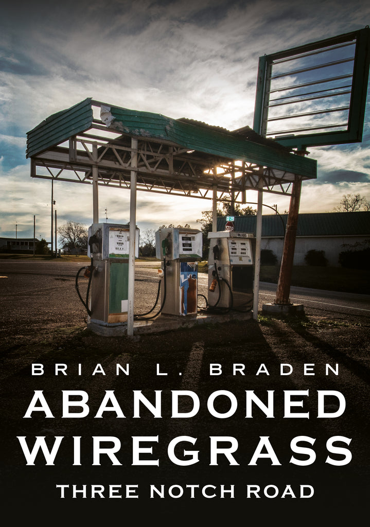 Abandoned gas station with vintage pumps under a cloudy sky, book cover of 'Abandoned Wiregrass' by Brian L. Braden.