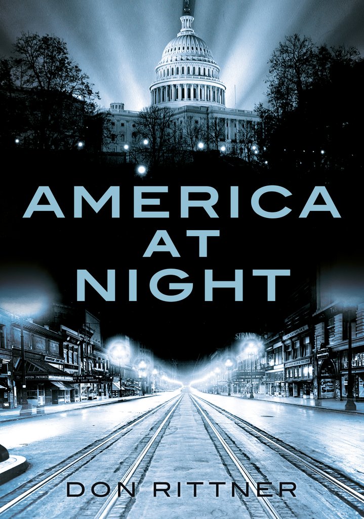 Cover of the book 'America at Night' displaying a black and white image of a cityscape at night with a subtle glow, featuring the author's name at the bottom.