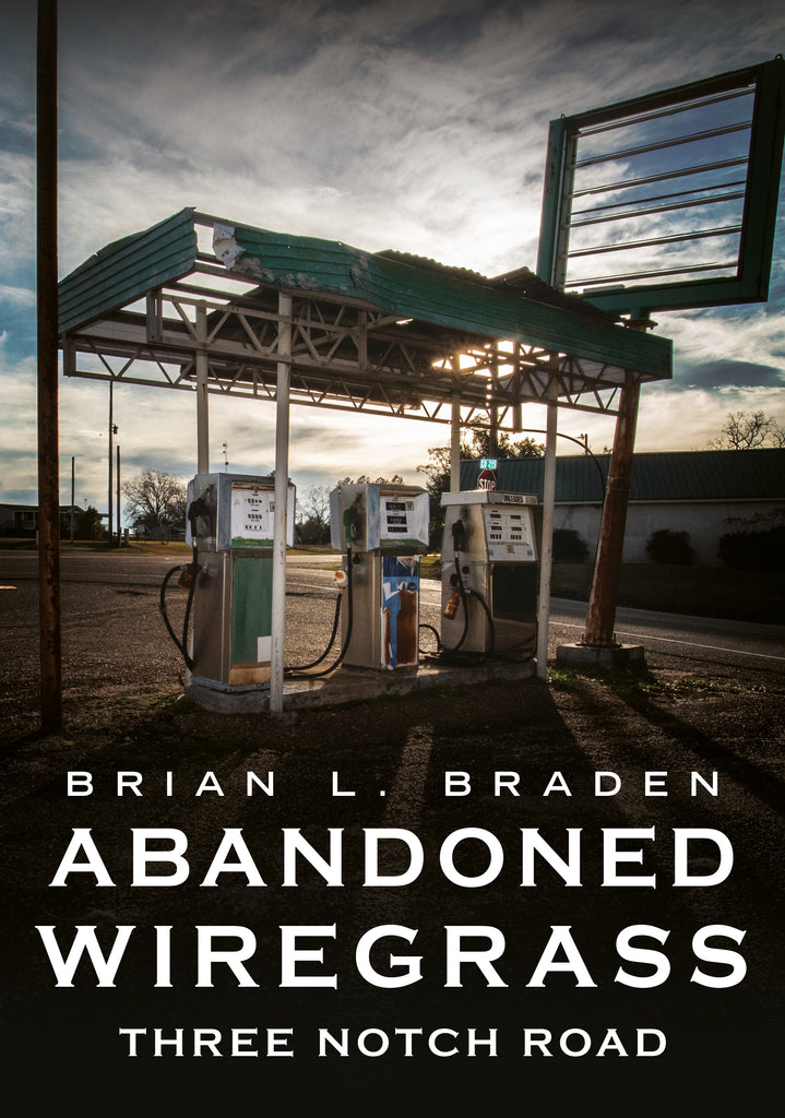 Abandoned gas station with vintage pumps under a cloudy sky, book cover of 'Abandoned Wiregrass' by Brian L. Braden.