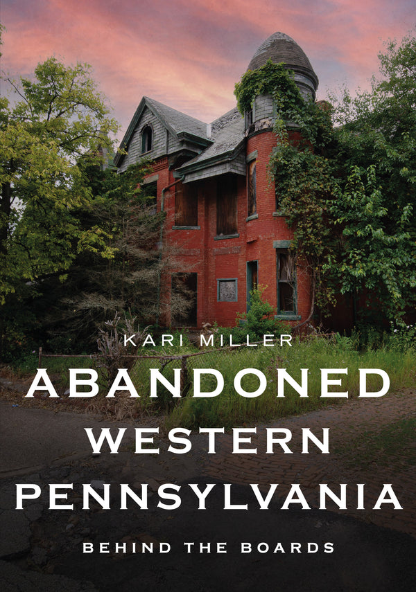 Cover of the book 'Abandoned Western Pennsylvania: Behind The Boards' showing a photograph of an old, dilapidated building with a tree growing in front and a clear sky in the background.
