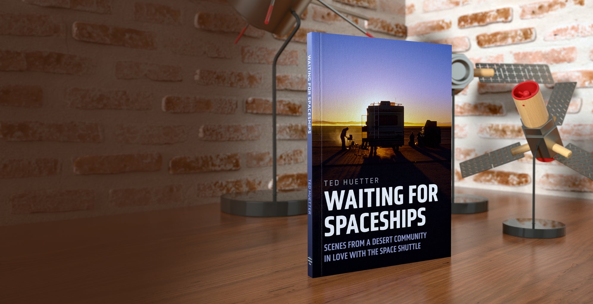 Book titled 'Waiting for Spaceships' by Ted Wester on a wooden surface with a brick wall background.