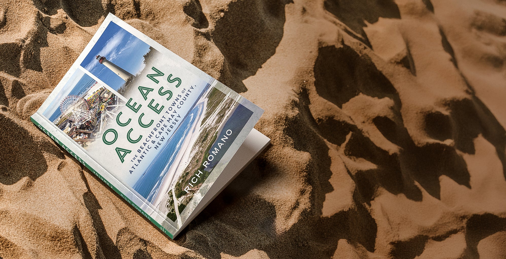 Book titled 'Ocean Access' by Rich Romano on sand, published by America Through Time.