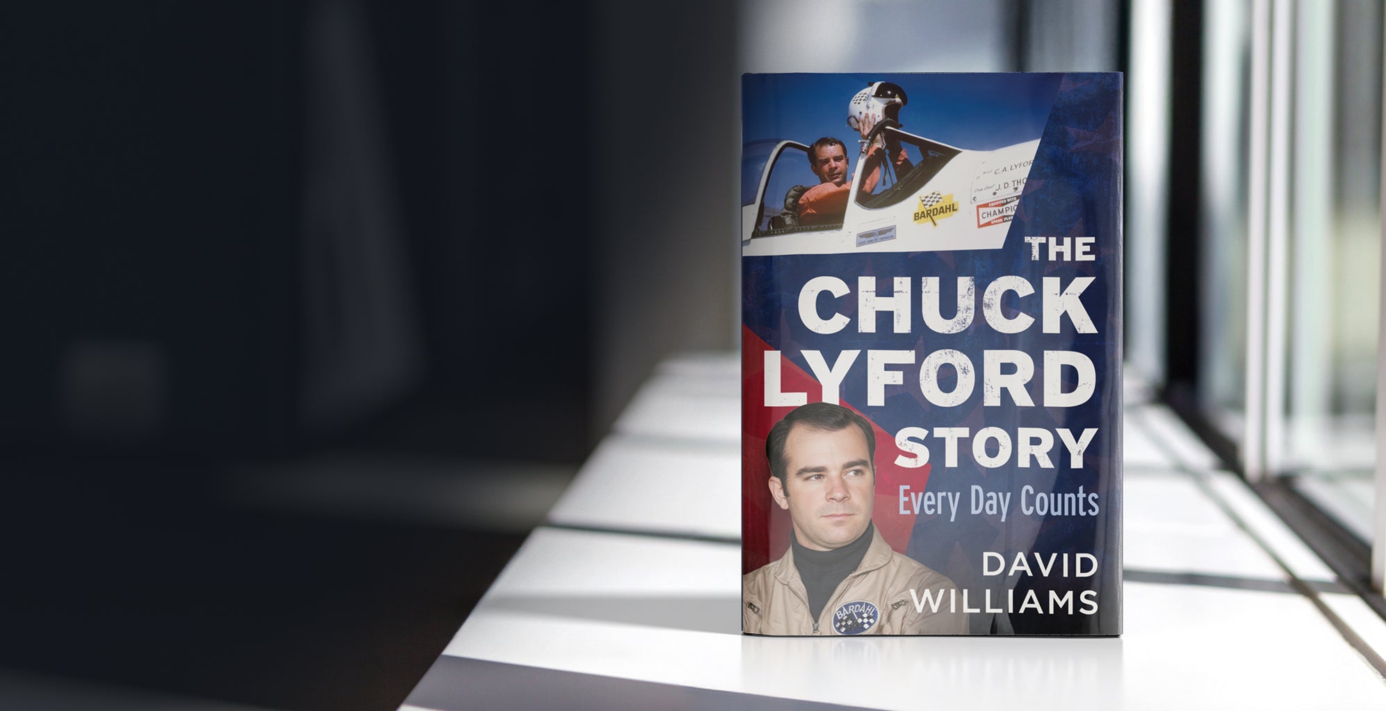 Book titled 'The Chuck Lyford Story: Every Day Counts' by David Williams on a reflective surface. Published by America Through Time - an imprint of Sutton Publishing Inc.