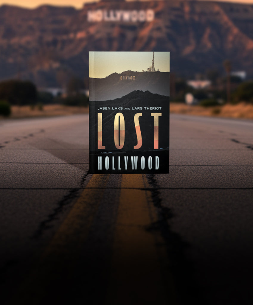 Book titled 'Lost Hollywood' on a road with the Hollywood sign in the background