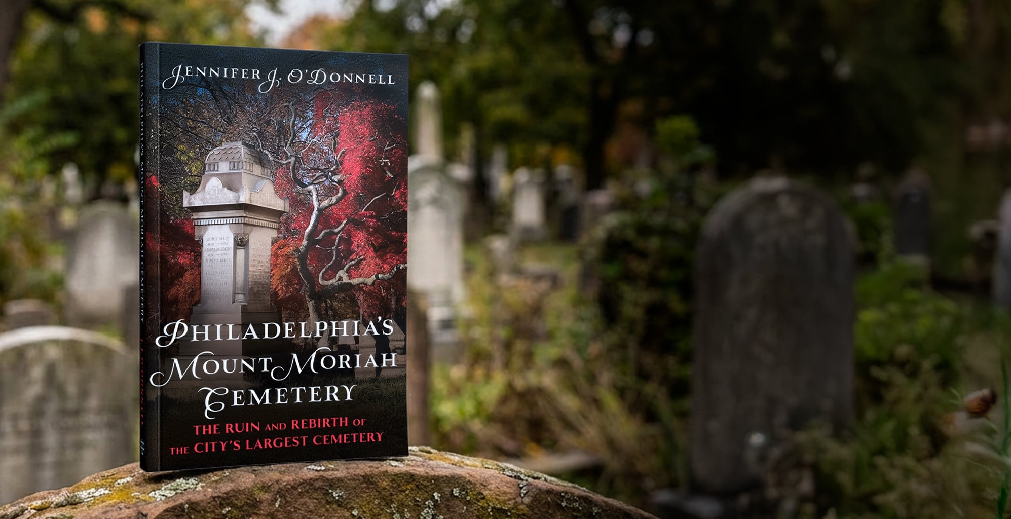 Book titled 'Philadelphia's Mount Moriah Cemetery' by Jennifer J. O'Donnell on a gravestone with a cemetery background.