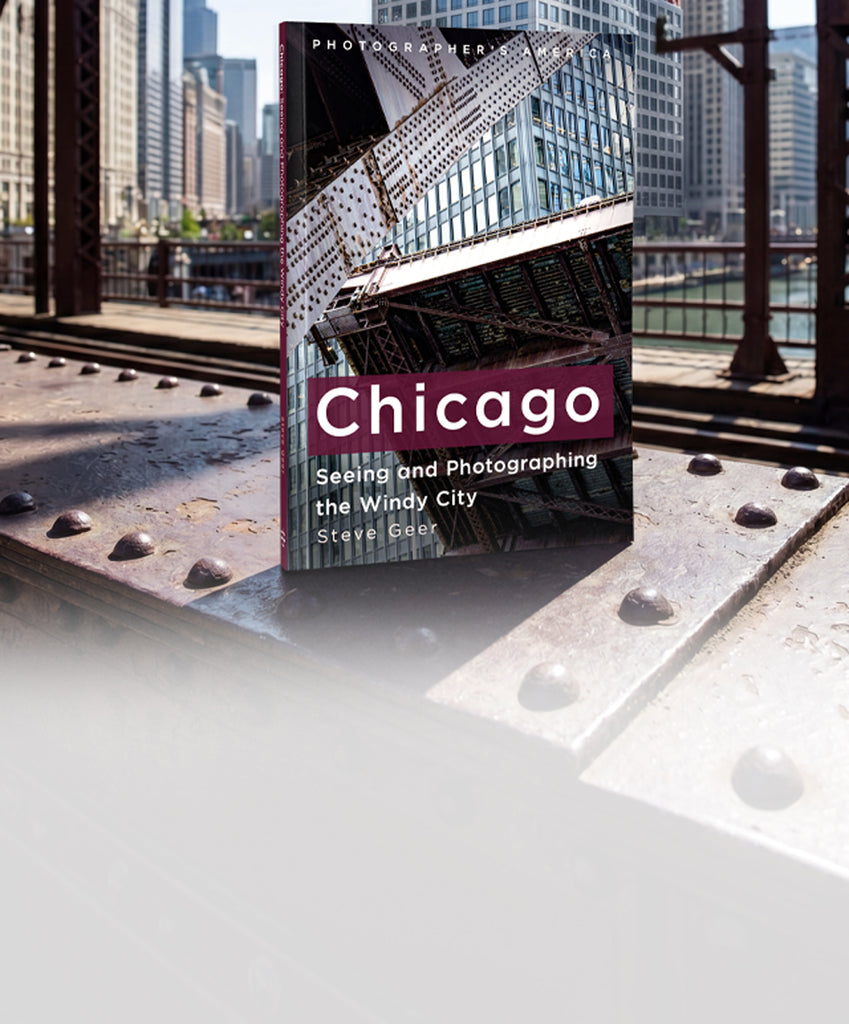 Book titled 'Chicago' by Steve Geer on a metal surface with cityscape background